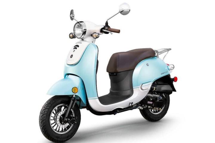 Light blue retro-style scooter with brown seat, side view.