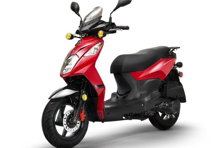 Red scooter with black seat and mirrors on a white background.